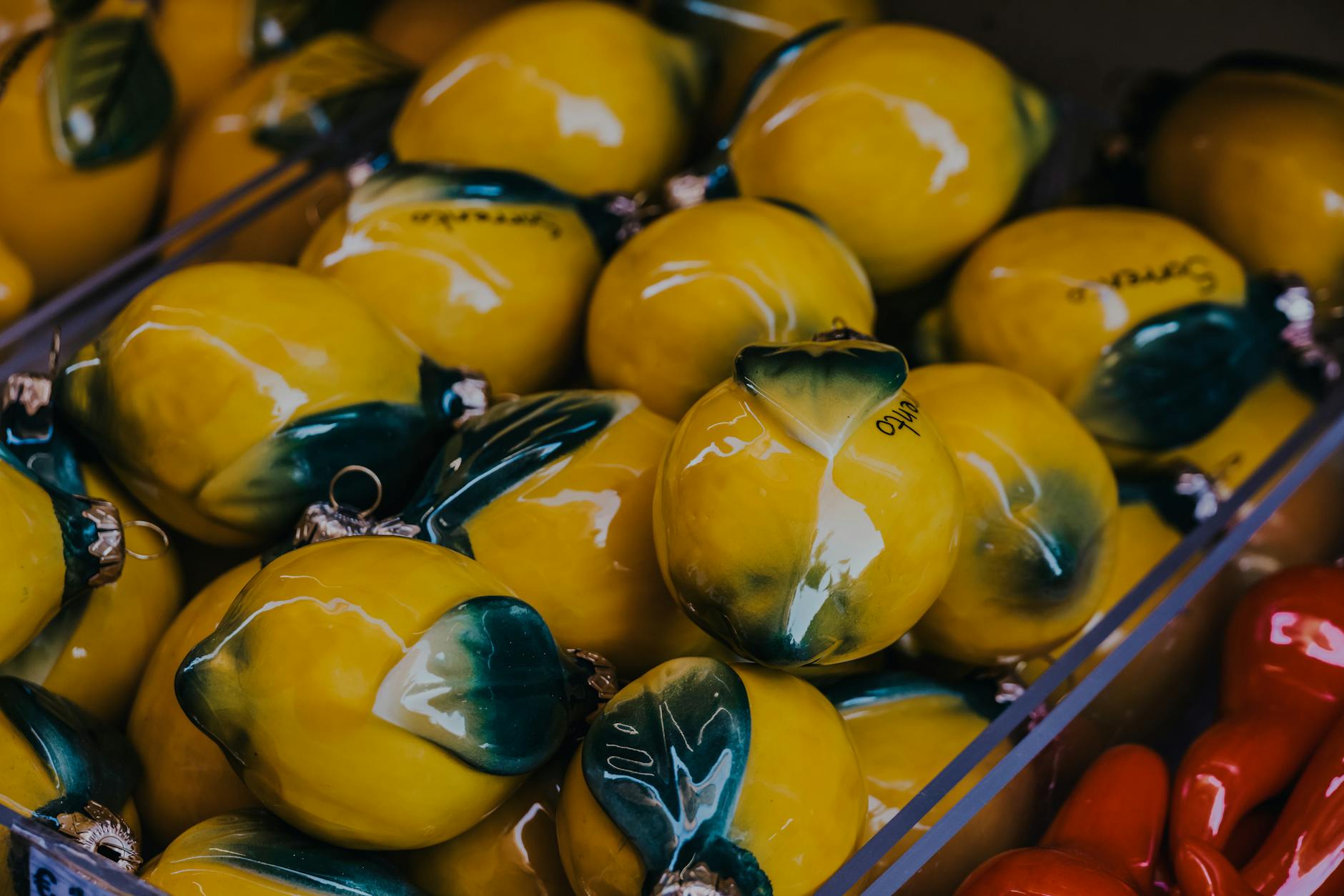 Yellow silicone clitoral vibrator displayed artfully among fresh fruit
