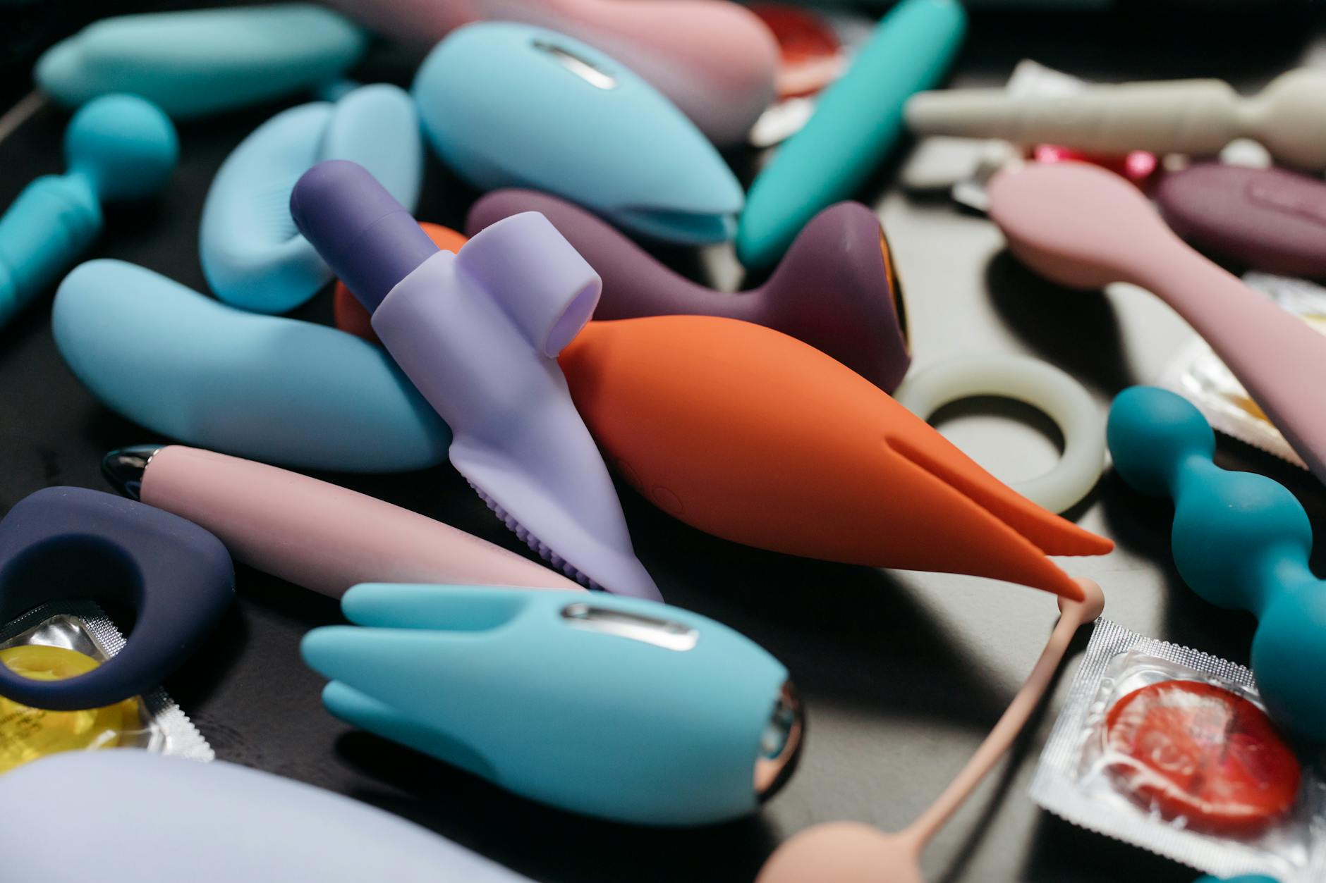 Woman holding colorful vibrators, representing pleasure tools for aging bodies.